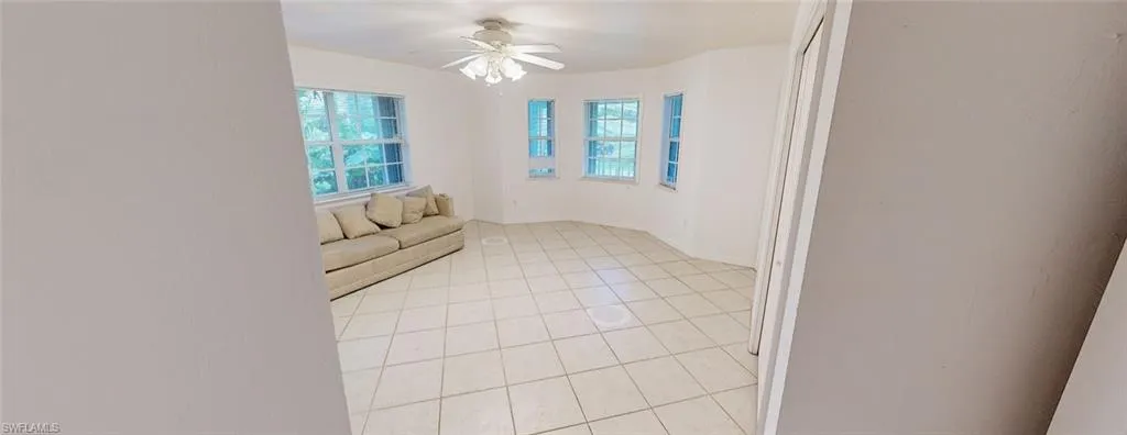Spare room featuring ceiling fan and light tile patterned floors