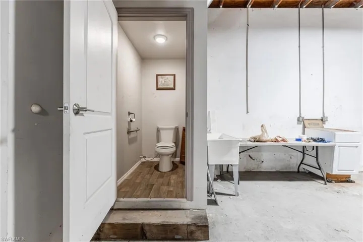 Garage Bathroom featuring vanity and unfinished concrete floors