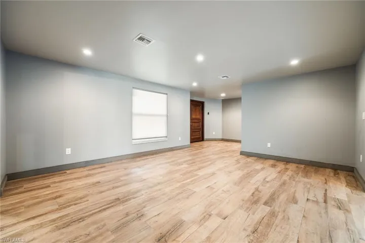 Spare room featuring light wood finished floors and recessed lighting