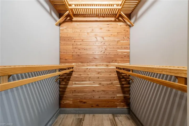 Spacious closet featuring light wood-style flooring