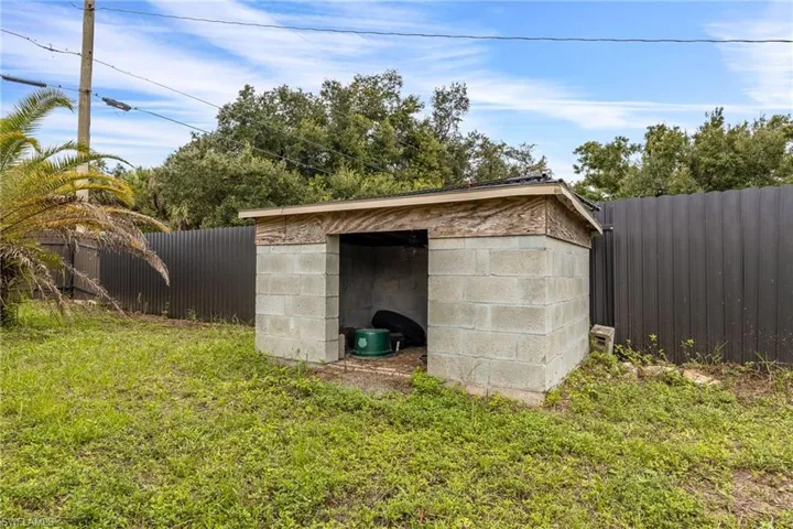 View of outdoor structure with a fenced backyard