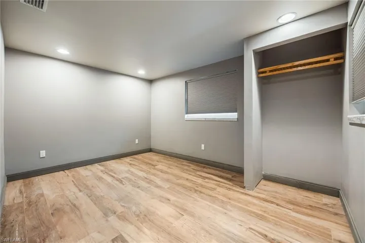 Unfurnished bedroom with light wood-type flooring, recessed lighting, and a closet