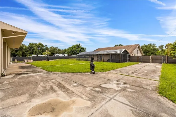 View of yard with concrete driveway