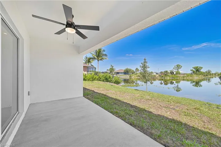 View of patio featuring a water view and a ceiling fan