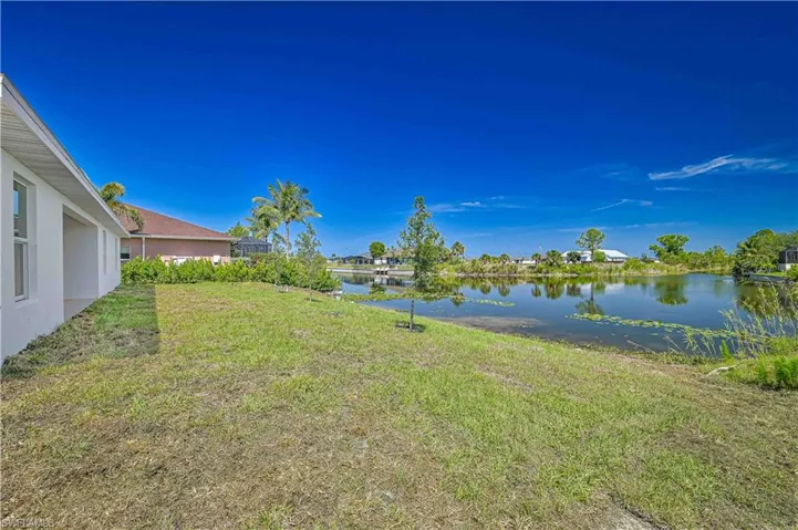 View of grassy yard featuring a view of  intersecting canals