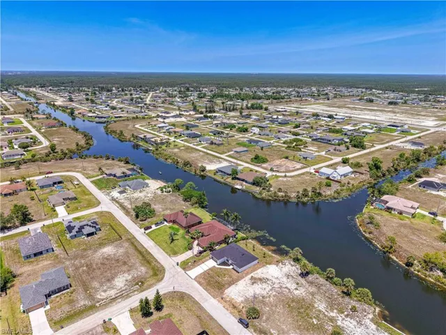 Aerial view of property and surrounding neighborhood featuring the intersecting canals