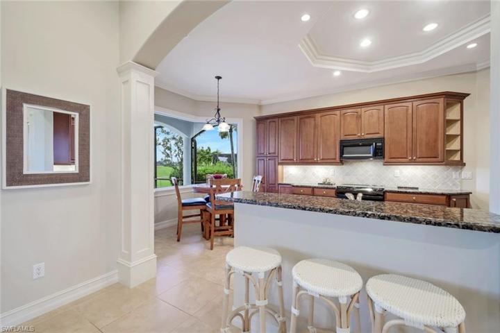 Kitchen has counter seating and a pool side breakfast nook