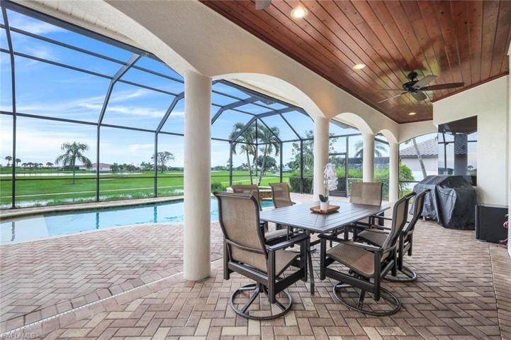 The large screened lanai has lots of room for covered dining, lounging, grilling - the beautiful wood ceiling treatment is another example of the custom, high quality finishes this home offers