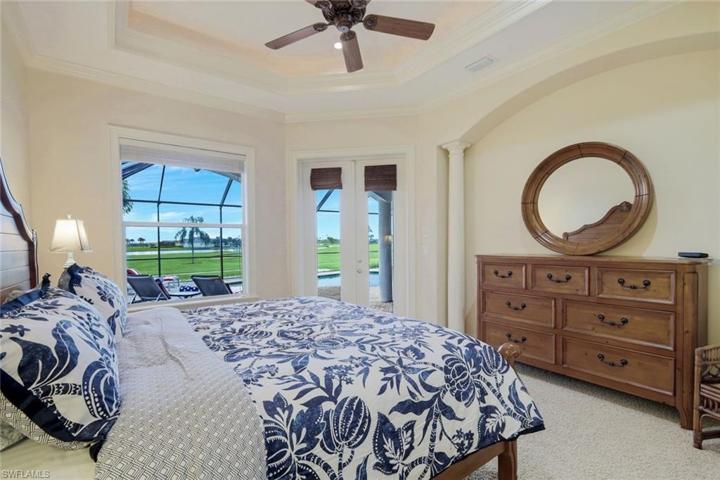 The spacious primary bedroom is light and bright with direct access to the pool
