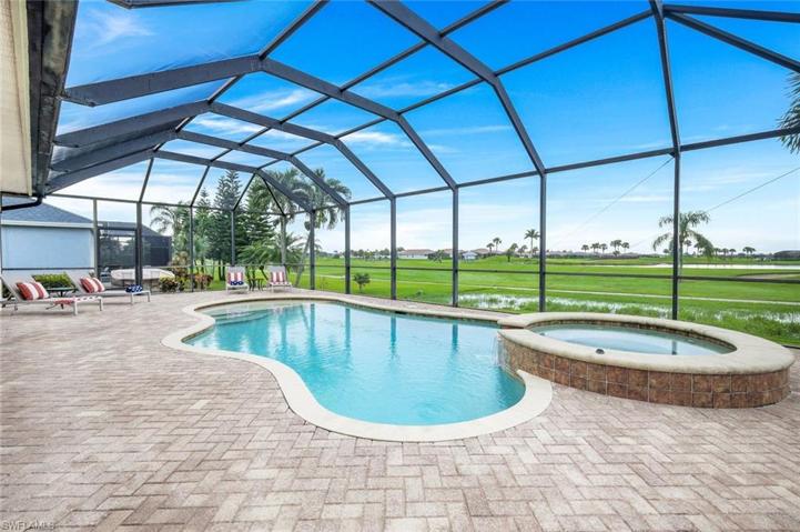 Paver stones on the pool deck and a green golf course view