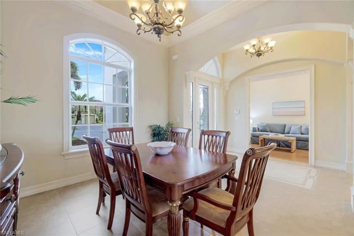 Spacious dining room has gorgeous coffered ceilings, great natural light