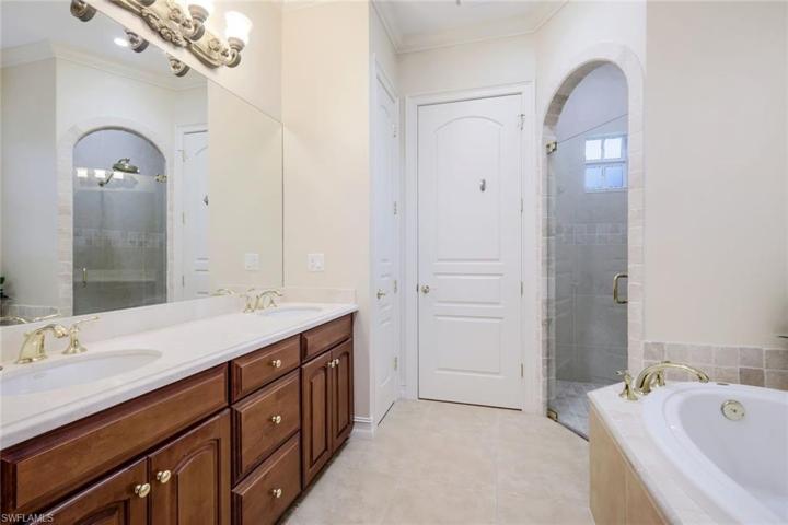 The en-suite primary bath has a soaking tub, separate shower, private toilet room and double sinks