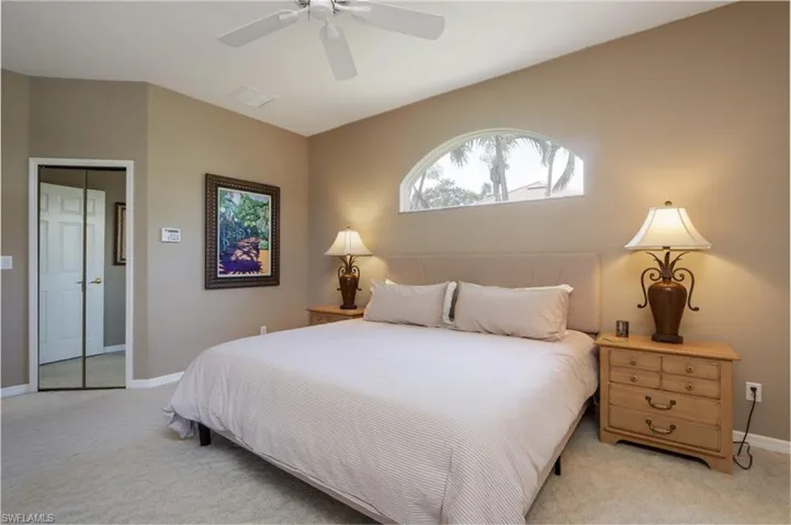 Bedroom with light colored carpet and ceiling fan