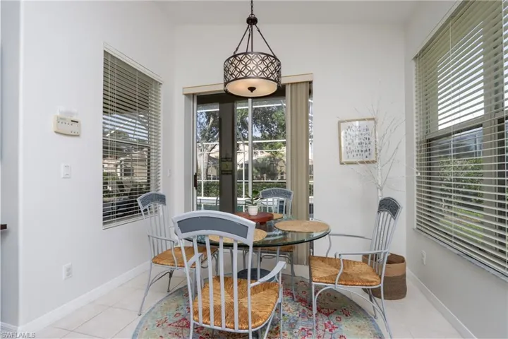 Dining room with plenty of natural light, light tile patterned floors, and french doors