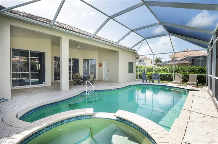 View of pool featuring a pool with connected hot tub, a patio, and a ceiling fan