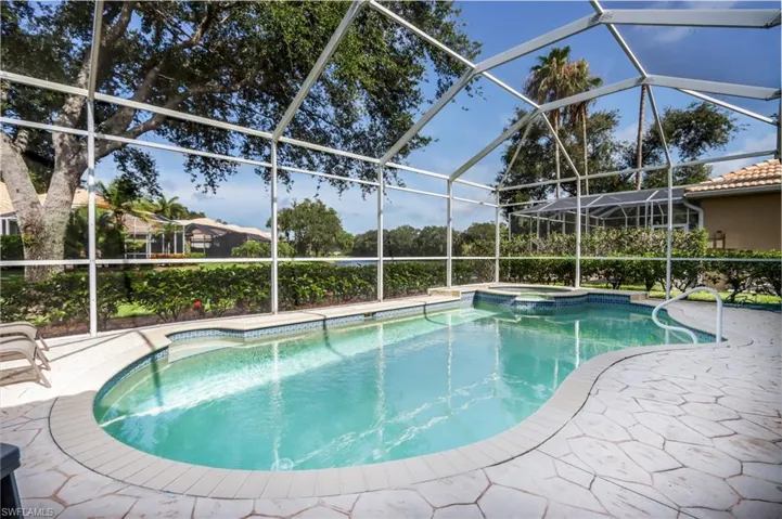 View of pool with a pool with connected hot tub, a lanai, and a patio