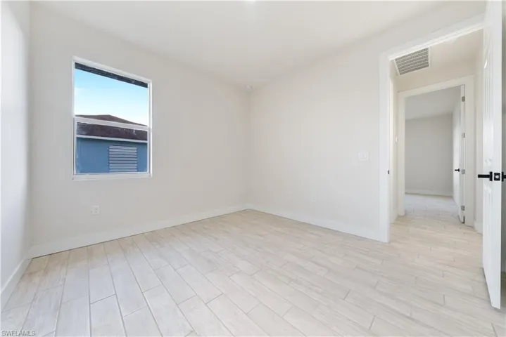 Spare room with wood finish floors and baseboards