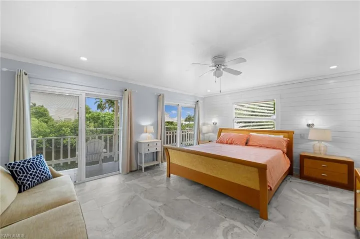 Bedroom with crown molding, access to exterior, multiple windows, and ceiling fan
