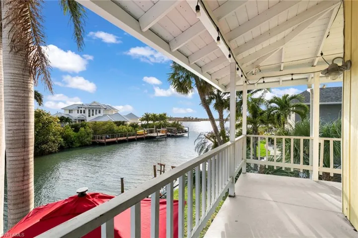 Balcony with a water view and a dock