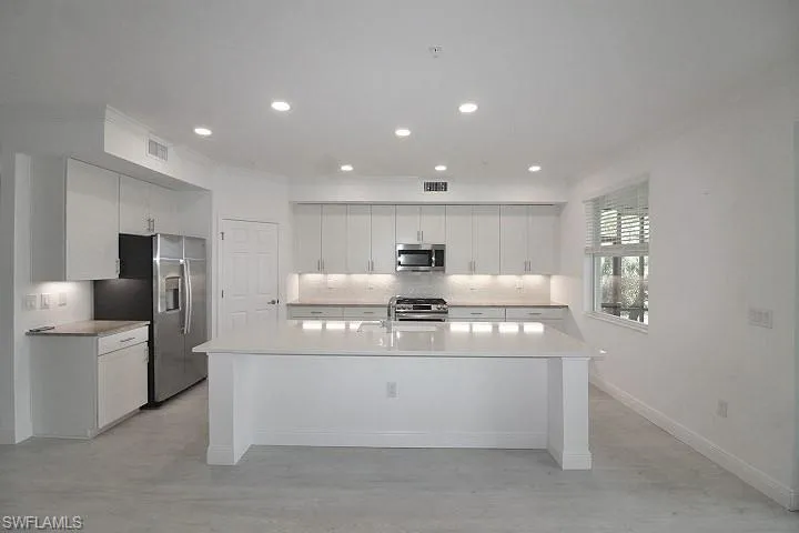 Clean lines and plenty of cabinet space. Walk-in pantry too!
