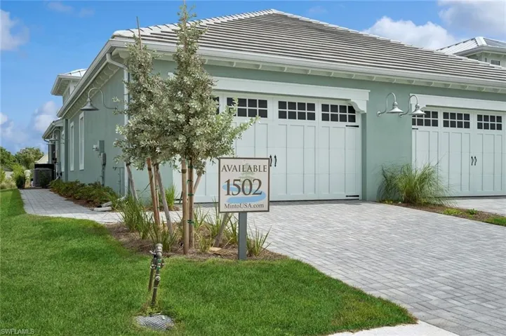 View of side of property featuring a garage and a yard