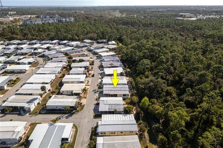 View of property location with a forest and nearby suburban area