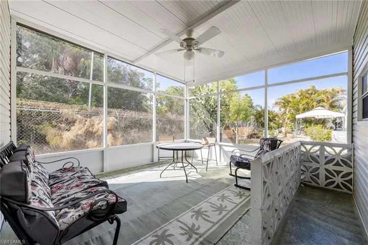 Sunroom / solarium with ceiling fan, healthy amount of natural light, and outdoor dining space