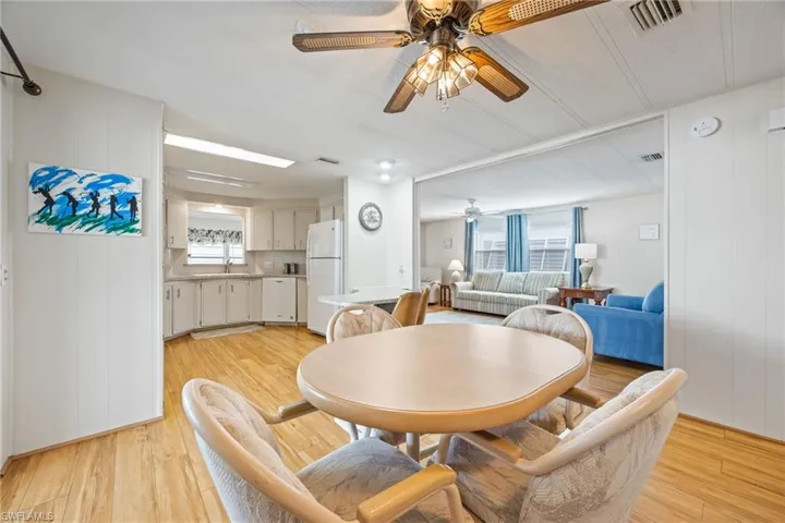 Dining space featuring a ceiling fan, light wood-style floors, and plenty of natural light