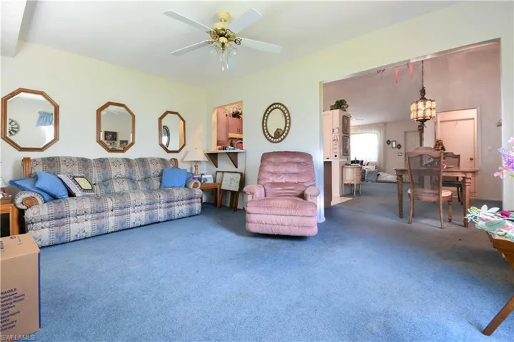 Living room featuring carpet flooring, ceiling fan