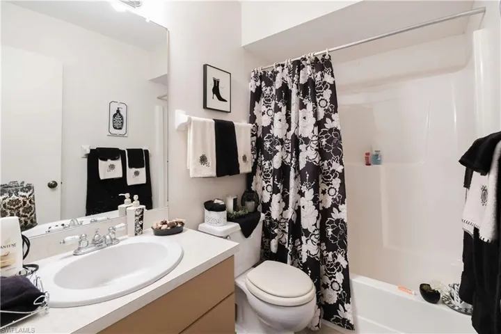 Bathroom with vanity and shower / tub combo with curtain