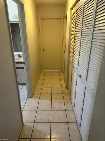Hallway with sink and light tile patterned flooring