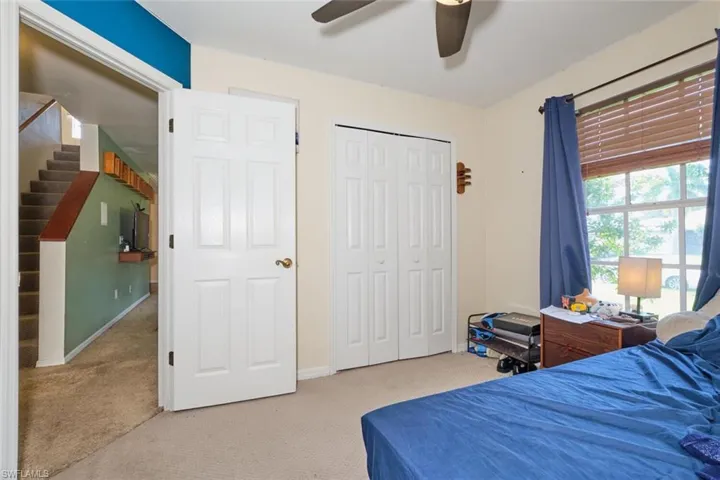 Bedroom featuring a closet, ceiling fan, and carpet flooring