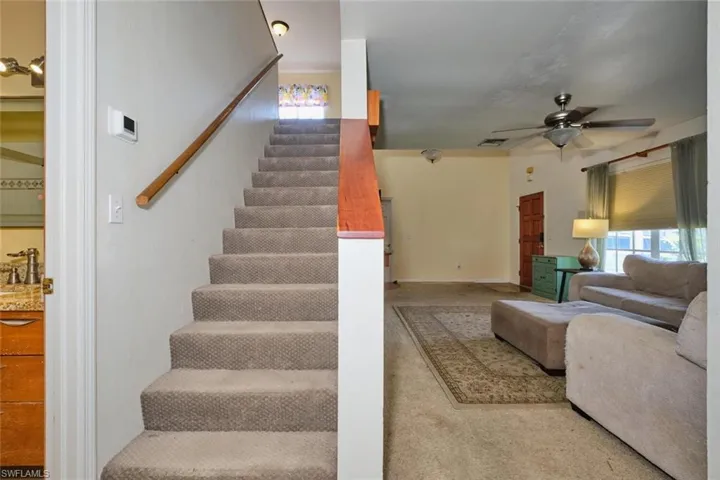Carpeted stairway to the upstairs bedroom and loft.  Nice and bright up there!