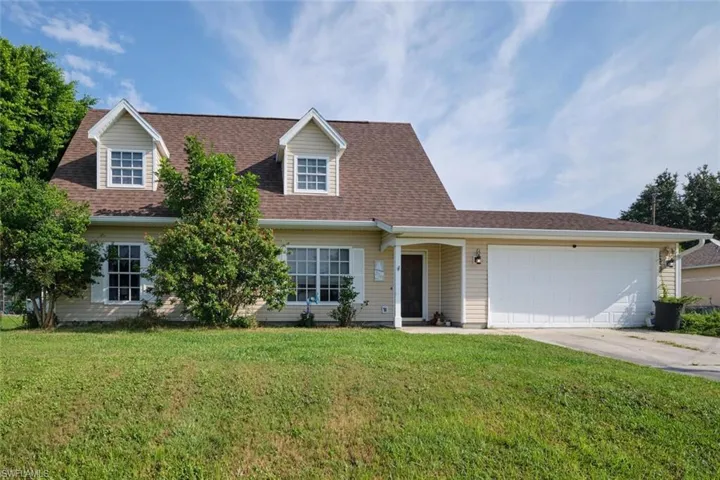 Front view of home with a two car garage.