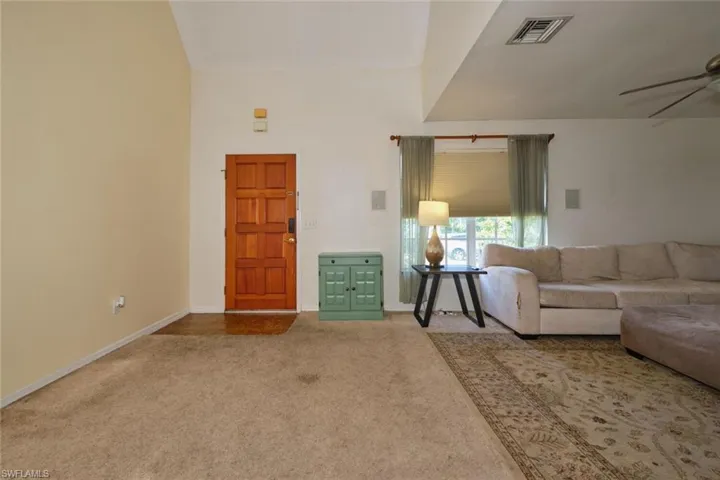 Entranceway into living room. Lots of open space there that can hold additional furniture such as a small dining room set or extra seating.  Nice high ceilings!