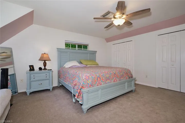 Carpeted bedroom with ceiling fan