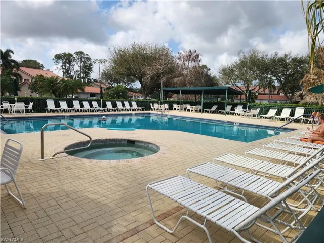 Community pool featuring a patio area and a community hot tub