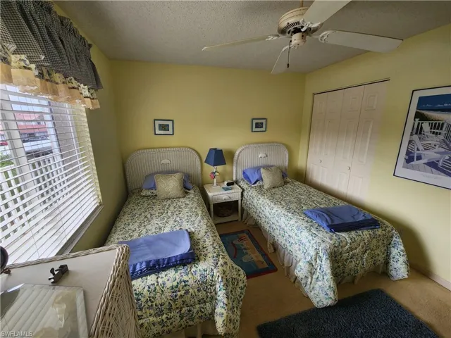 Bedroom featuring carpet floors, a closet, and ceiling fan