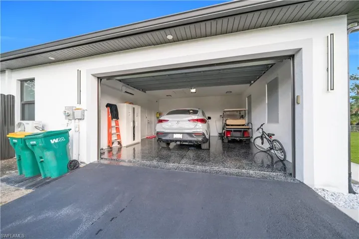 Garage featuring a wall mounted air conditioner