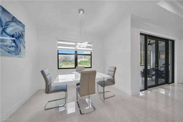 Dining area featuring baseboards and a chandelier