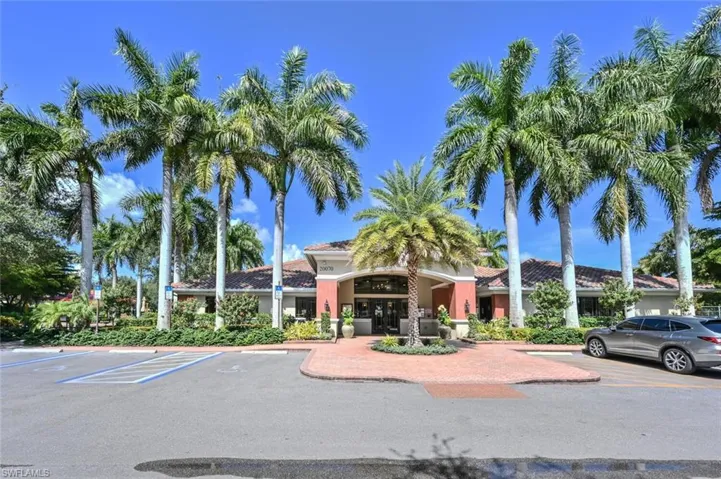 View of property featuring uncovered parking
