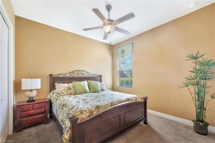Bedroom with carpet floors, a closet, and a ceiling fan