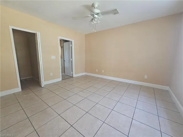 Spare room featuring baseboards and a ceiling fan