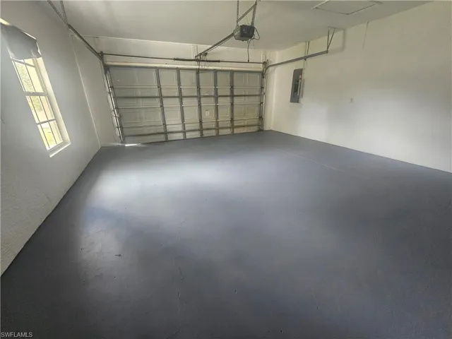 Garage with electric panel and a garage door opener