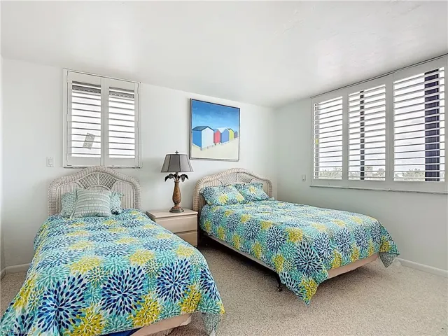 Bedroom with carpet and multiple windows