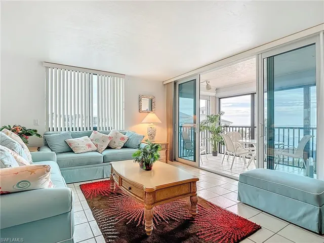 Tiled living room featuring a textured ceiling and Gulf view