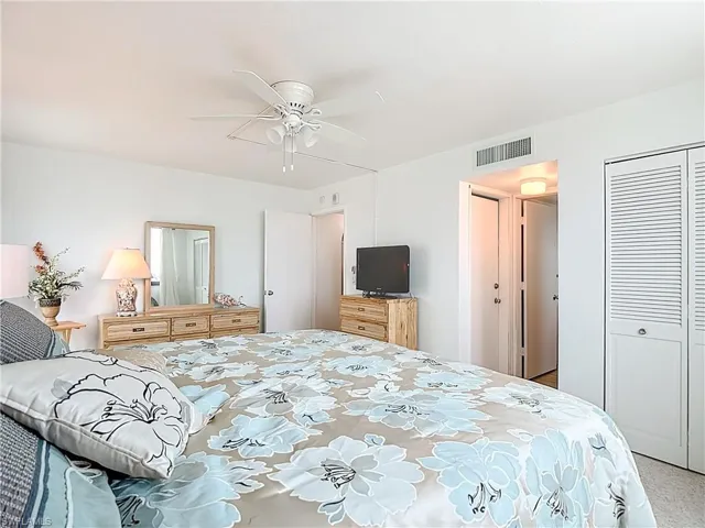 Bedroom featuring ceiling fan and a closet