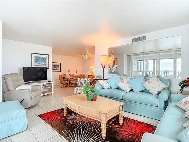 Living area with tile patterned flooring and a ceiling fan