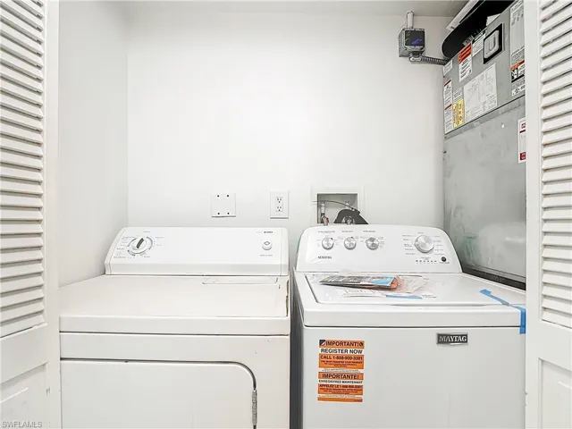 Laundry room featuring washing machine and clothes dryer and heating unit
