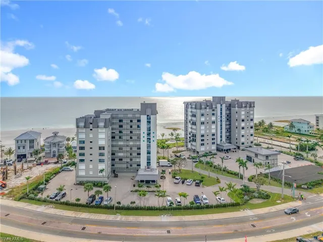 Aerial view of expansive coastline and apartment complex / building